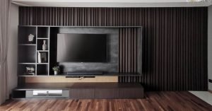 Contemporary furnishings and statement lighting in a moody coloured condo at The Tamarind Penang.